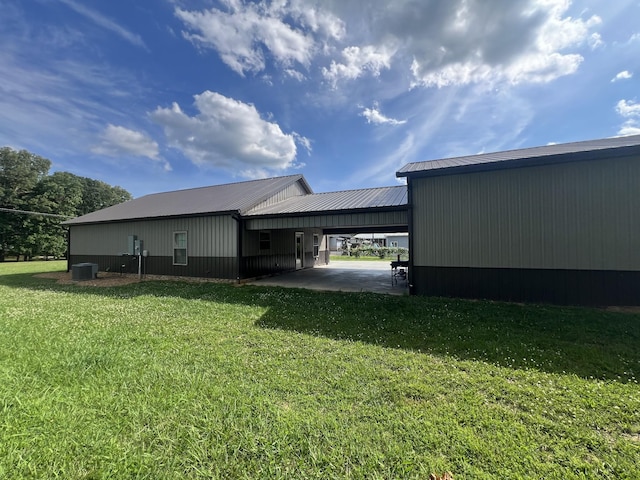108 Chase Bend Rd, Estill Springs, TN 37330 - view of side of home with an attached carport, a yard, and a metal roof