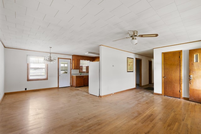 604 2nd Ave, Lawrenceburg, TN 38464 - unfurnished living room featuring a chandelier, a ceiling fan, and light wood-style floors