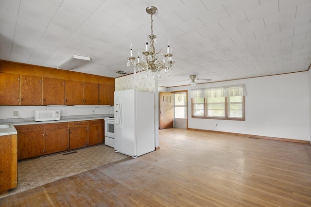 604 2nd Ave, Lawrenceburg, TN 38464 - kitchen with white appliances, brown cabinets, light wood-type flooring, light countertops, and a chandelier