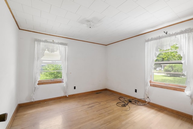 604 2nd Ave, Lawrenceburg, TN 38464 - unfurnished room with crown molding, healthy amount of natural light, and light wood-style flooring