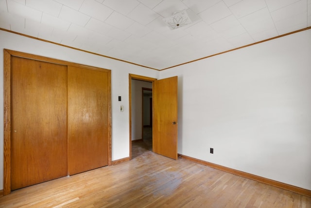 604 2nd Ave, Lawrenceburg, TN 38464 - unfurnished bedroom with crown molding, wood finished floors, and a closet