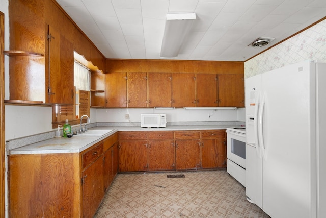 604 2nd Ave, Lawrenceburg, TN 38464 - kitchen featuring white appliances, brown cabinetry, light countertops, and light flooring