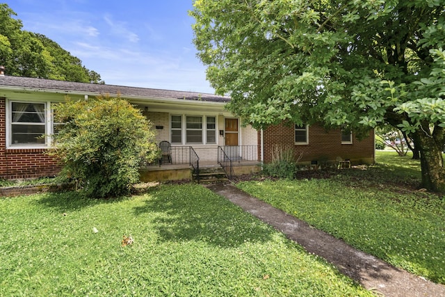 604 2nd Ave, Lawrenceburg, TN 38464 - view of front of property with brick siding, a front yard, and a porch