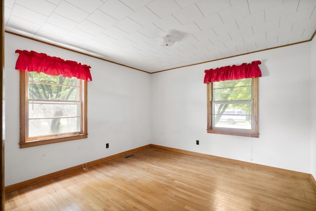 604 2nd Ave, Lawrenceburg, TN 38464 - spare room featuring healthy amount of natural light, light wood-style flooring, and crown molding