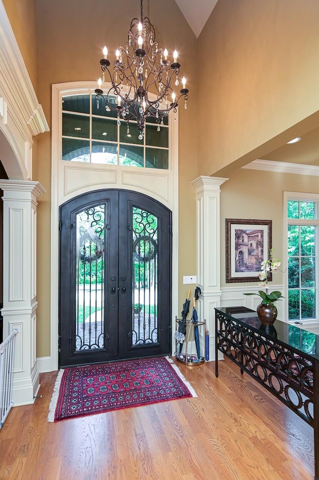 205 Nature Ridge Rd, Tullahoma, TN 37388 - entryway with wood finished floors, high vaulted ceiling, french doors, a chandelier, and ornate columns