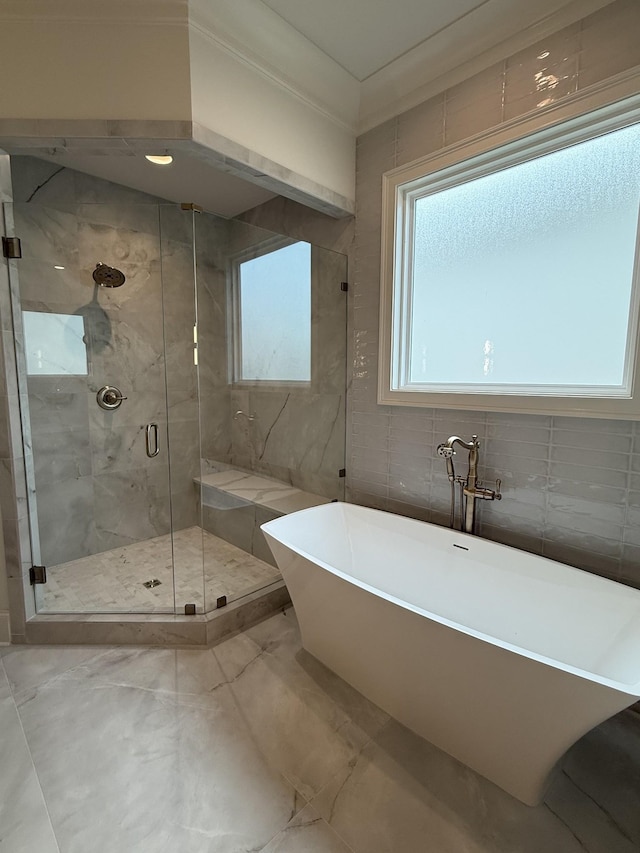 8006 Southvale Blvd, Franklin, TN 37064 - full bathroom featuring a freestanding bath, marble finish flooring, tile walls, and a stall shower