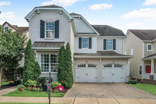 312 Rafferty Ct, Franklin, TN 37064 - view of front facade featuring brick siding, a garage, driveway, a standing seam roof, and roof with shingles