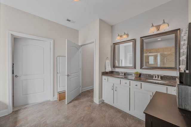 312 Rafferty Ct, Franklin, TN 37064 - bathroom featuring a tile shower and double vanity