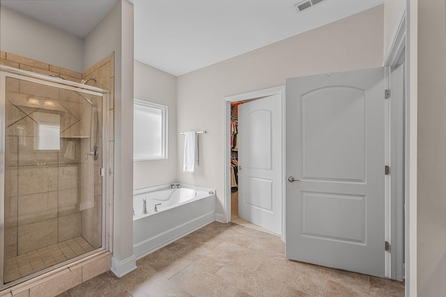 312 Rafferty Ct, Franklin, TN 37064 - full bathroom featuring a bath, a stall shower, and a walk in closet