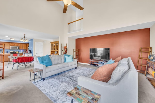 3299 Twelve Oaks Blvd, Clarksville, TN 37042 - living area with light colored carpet, a ceiling fan, a high ceiling, and a chandelier