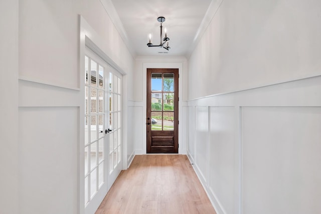 169 Willow Bend Dr, Hendersonville, TN 37075 - doorway to outside with a decorative wall, light wood-type flooring, a chandelier, wainscoting, and french doors
