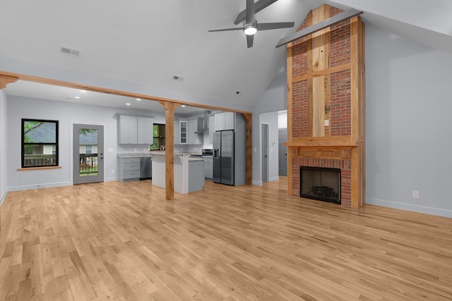 414 Ault Rd, Signal Mountain, TN 37377 - unfurnished living room featuring high vaulted ceiling, a fireplace, ceiling fan, light wood finished floors, and recessed lighting