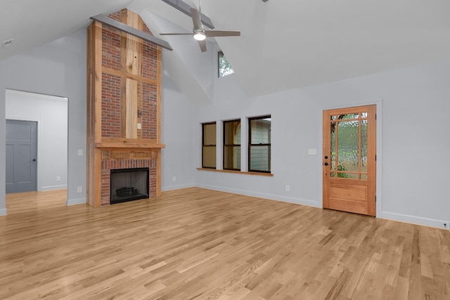 414 Ault Rd, Signal Mountain, TN 37377 - unfurnished living room with high vaulted ceiling, ceiling fan, light wood-type flooring, a fireplace, and beam ceiling