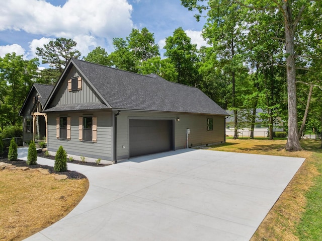 414 Ault Rd, Signal Mountain, TN 37377 - view of home's exterior featuring concrete driveway, a garage, board and batten siding, roof with shingles, and a yard