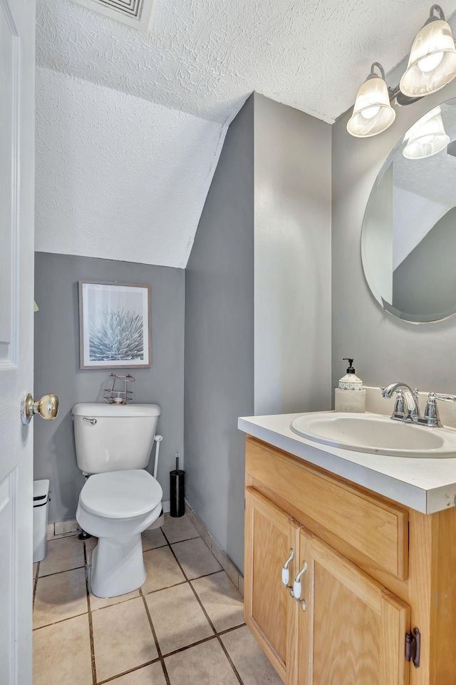 5601 Murphywood Xing, Antioch, TN 37013 - bathroom with a textured ceiling, vanity, vaulted ceiling, and tile patterned flooring