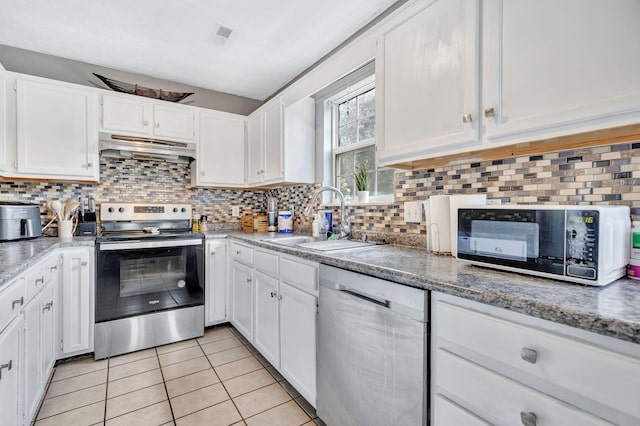 5601 Murphywood Xing, Antioch, TN 37013 - kitchen with appliances with stainless steel finishes, under cabinet range hood, white cabinets, and light tile patterned flooring