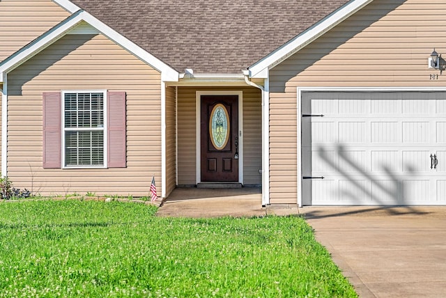 141 Bob White Trl, Oak Grove, KY 42262 - property entrance featuring a garage, concrete driveway, a shingled roof, and a yard