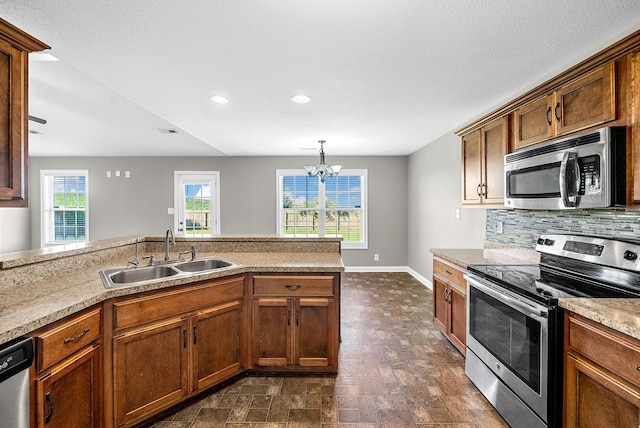 141 Bob White Trl, Oak Grove, KY 42262 - kitchen featuring stainless steel appliances, backsplash, a chandelier, recessed lighting, and light countertops