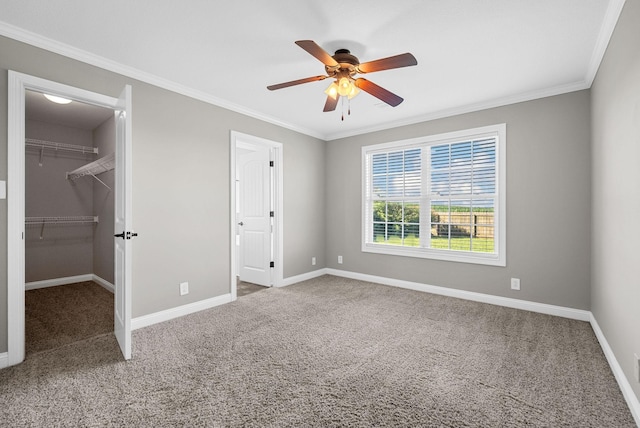 141 Bob White Trl, Oak Grove, KY 42262 - unfurnished bedroom featuring carpet flooring, ornamental molding, a walk in closet, a ceiling fan, and a closet