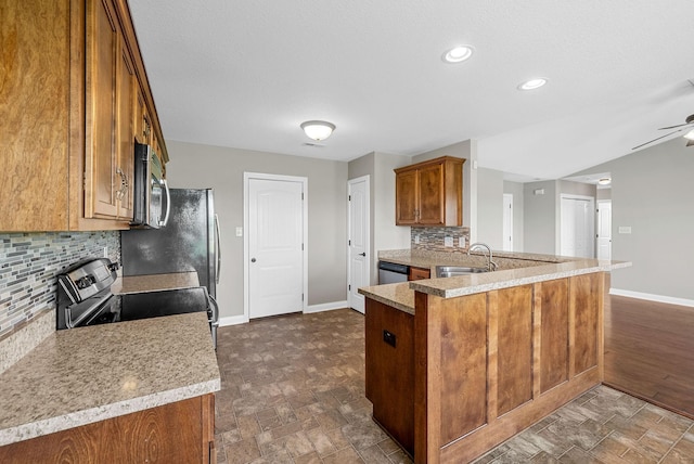 141 Bob White Trl, Oak Grove, KY 42262 - kitchen featuring stainless steel appliances, brown cabinets, backsplash, ceiling fan, and light countertops