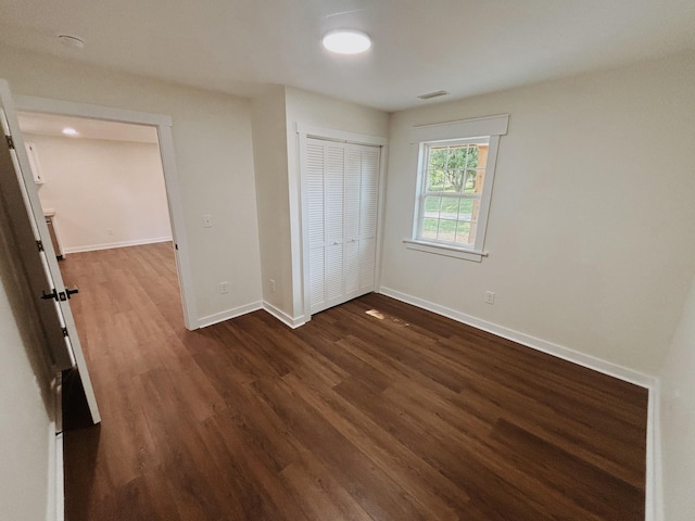 210 N Vine St, Tullahoma, TN 37388 - unfurnished bedroom featuring dark wood-style floors and a closet