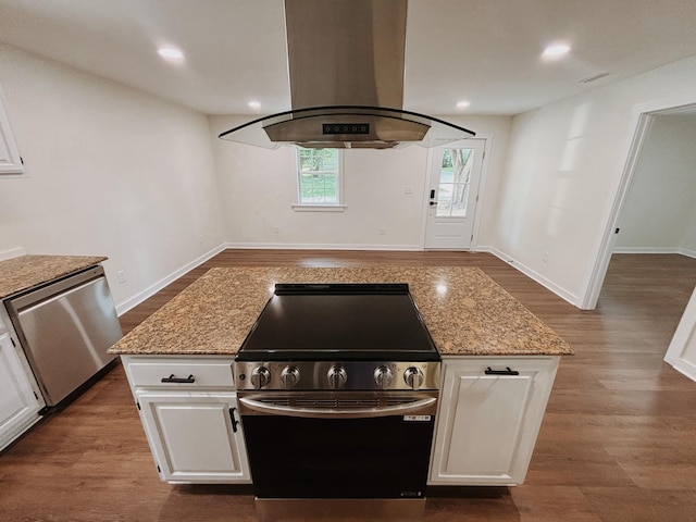 210 N Vine St, Tullahoma, TN 37388 - kitchen with island exhaust hood, appliances with stainless steel finishes, dark wood finished floors, white cabinetry, and light stone countertops