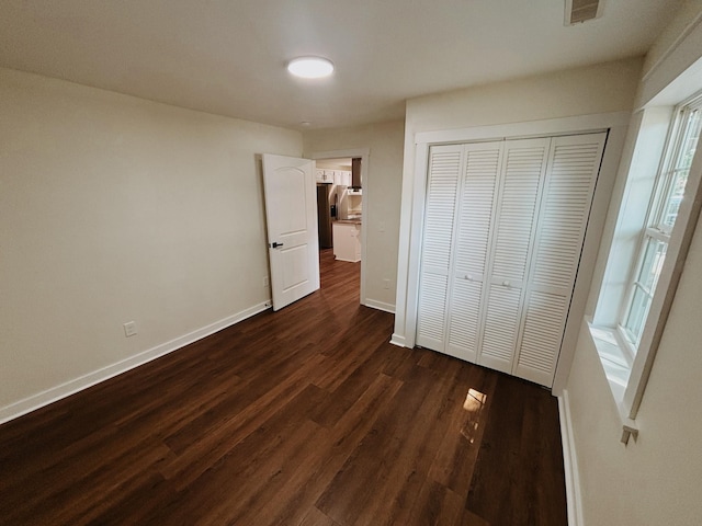 210 N Vine St, Tullahoma, TN 37388 - unfurnished bedroom with dark wood-type flooring and a closet