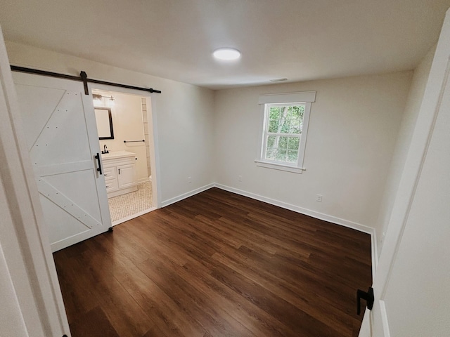 210 N Vine St, Tullahoma, TN 37388 - unfurnished room with a barn door and dark wood-style flooring