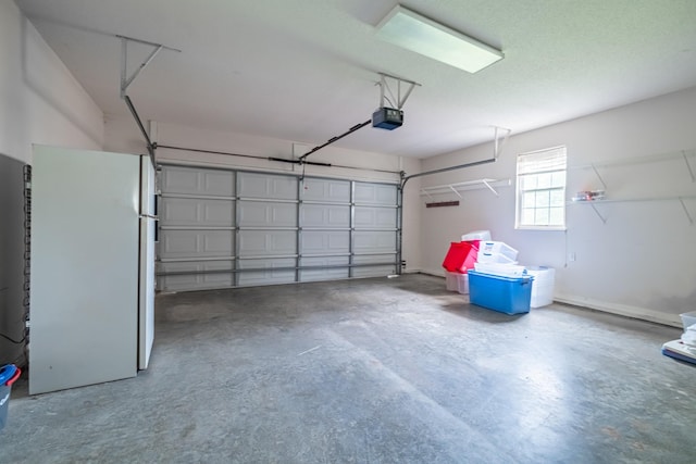 218 Susie Dr, Winchester, TN 37398 - garage featuring freestanding refrigerator and a garage door opener