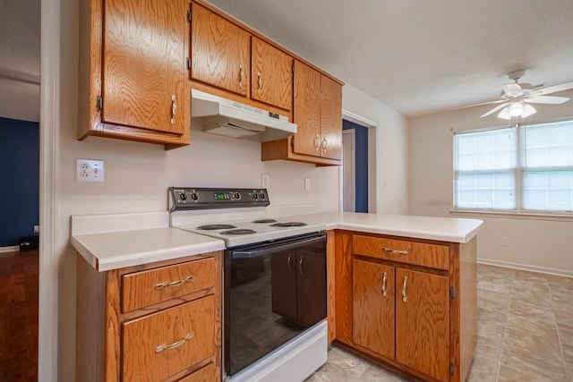 218 Susie Dr, Winchester, TN 37398 - kitchen featuring white electric range oven, under cabinet range hood, a peninsula, light countertops, and brown cabinets