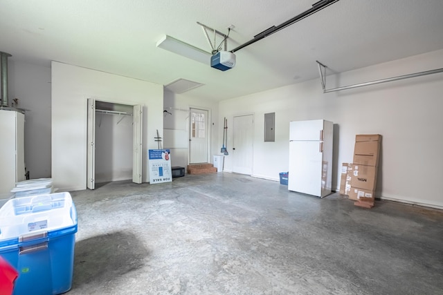 218 Susie Dr, Winchester, TN 37398 - garage featuring freestanding refrigerator, electric panel, and a garage door opener