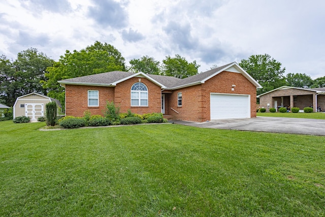 218 Susie Dr, Winchester, TN 37398 - single story home featuring driveway, brick siding, an attached garage, a front yard, and a storage shed
