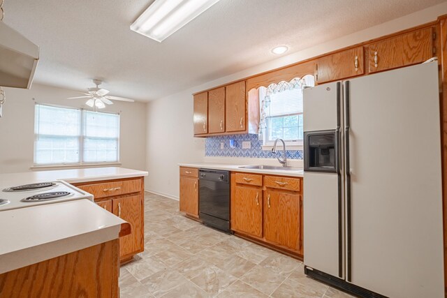 218 Susie Dr, Winchester, TN 37398 - kitchen featuring white fridge with ice dispenser, black dishwasher, light countertops, a ceiling fan, and brown cabinets