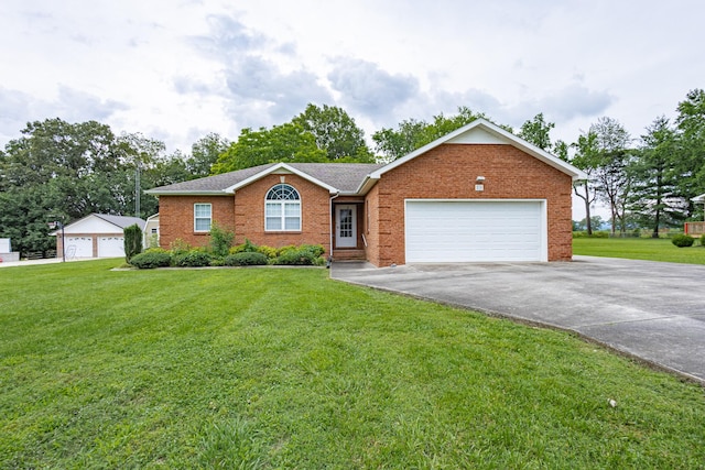 218 Susie Dr, Winchester, TN 37398 - single story home with asphalt driveway, brick siding, a front yard, an attached garage, and a shingled roof