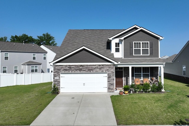 7050 Scotlyn Way, White House, TN 37188 - view of front of home featuring driveway, stone siding, an attached garage, covered porch, and a shingled roof