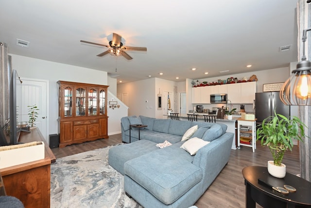 7050 Scotlyn Way, White House, TN 37188 - living room featuring a ceiling fan, wood finished floors, stairs, and recessed lighting