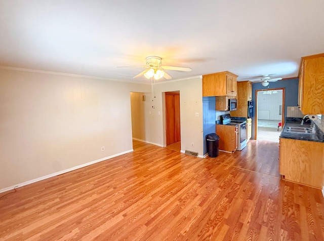 115 Horseshoe St, Pulaski, TN 38478 - kitchen with white electric range oven, ceiling fan, stainless steel microwave, light wood-style flooring, and crown molding
