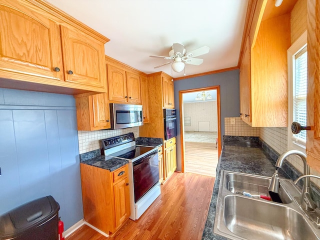 115 Horseshoe St, Pulaski, TN 38478 - kitchen with stainless steel microwave, electric stove, oven, light wood-style flooring, and ornamental molding