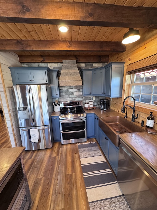 139 E Swan Ridge Rd, Hilham, TN 38568 - kitchen featuring appliances with stainless steel finishes, premium range hood, blue cabinets, a wooden ceiling with exposed beams, and dark wood-type flooring