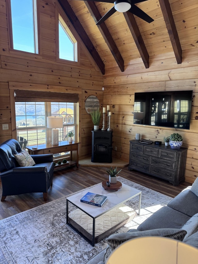 139 E Swan Ridge Rd, Hilham, TN 38568 - living room with a wood ceiling with exposed beams, wooden walls, wood finished floors, healthy amount of natural light, and a ceiling fan