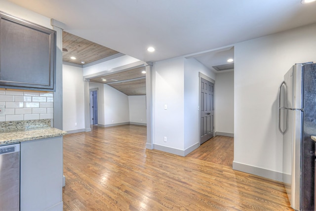 1205 Dr Db Todd Jr Blvd, Nashville, TN 37208 - kitchen with stainless steel appliances, light wood-style floors, recessed lighting, backsplash, and light stone countertops