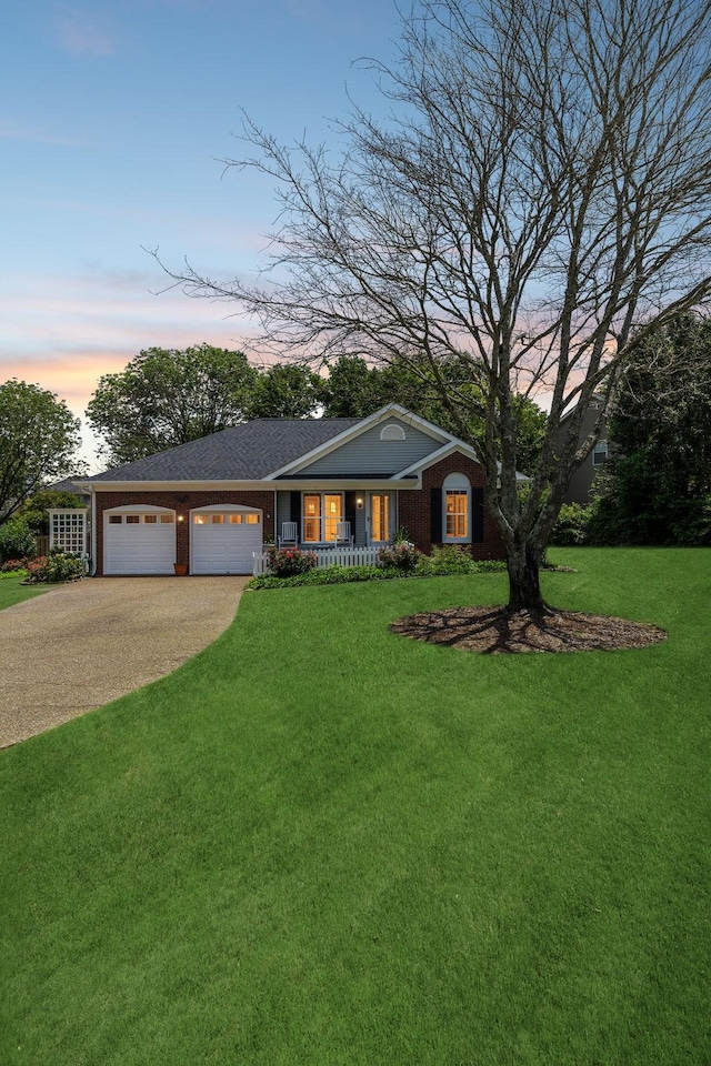 227 Riverbend Dr, Franklin, TN 37064 - single story home with a porch, a yard, an attached garage, and driveway