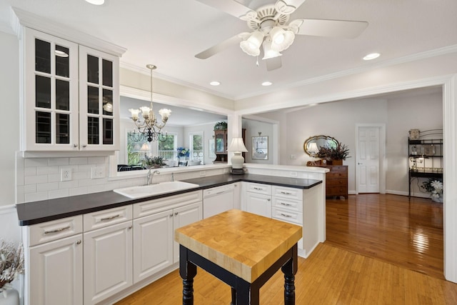 227 Riverbend Dr, Franklin, TN 37064 - kitchen featuring white dishwasher, dark countertops, glass insert cabinets, ceiling fan, and light wood-style flooring