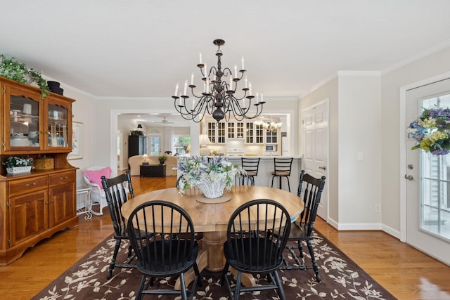 227 Riverbend Dr, Franklin, TN 37064 - dining space featuring light wood-type flooring, a chandelier, healthy amount of natural light, and crown molding
