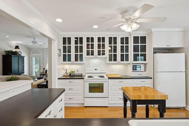 227 Riverbend Dr, Franklin, TN 37064 - kitchen with white appliances, ceiling fan, dark countertops, glass insert cabinets, and ornamental molding