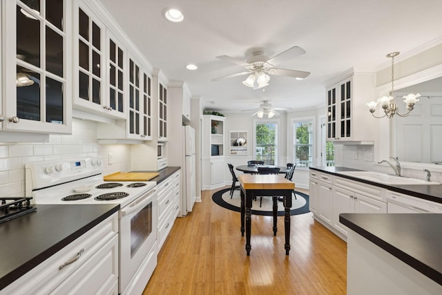 227 Riverbend Dr, Franklin, TN 37064 - kitchen with white appliances, dark countertops, recessed lighting, white cabinets, and tasteful backsplash