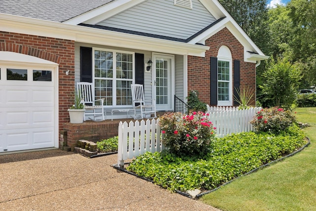 227 Riverbend Dr, Franklin, TN 37064 - view of exterior entry with a porch, brick siding, concrete driveway, and a garage