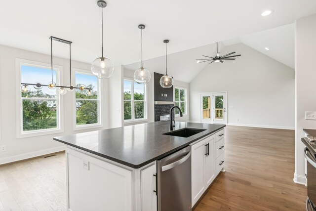 512 Smokey Rdg, Nolensville, TN 37135 - kitchen featuring dishwasher, dark countertops, a kitchen island with sink, light wood-type flooring, and white cabinetry