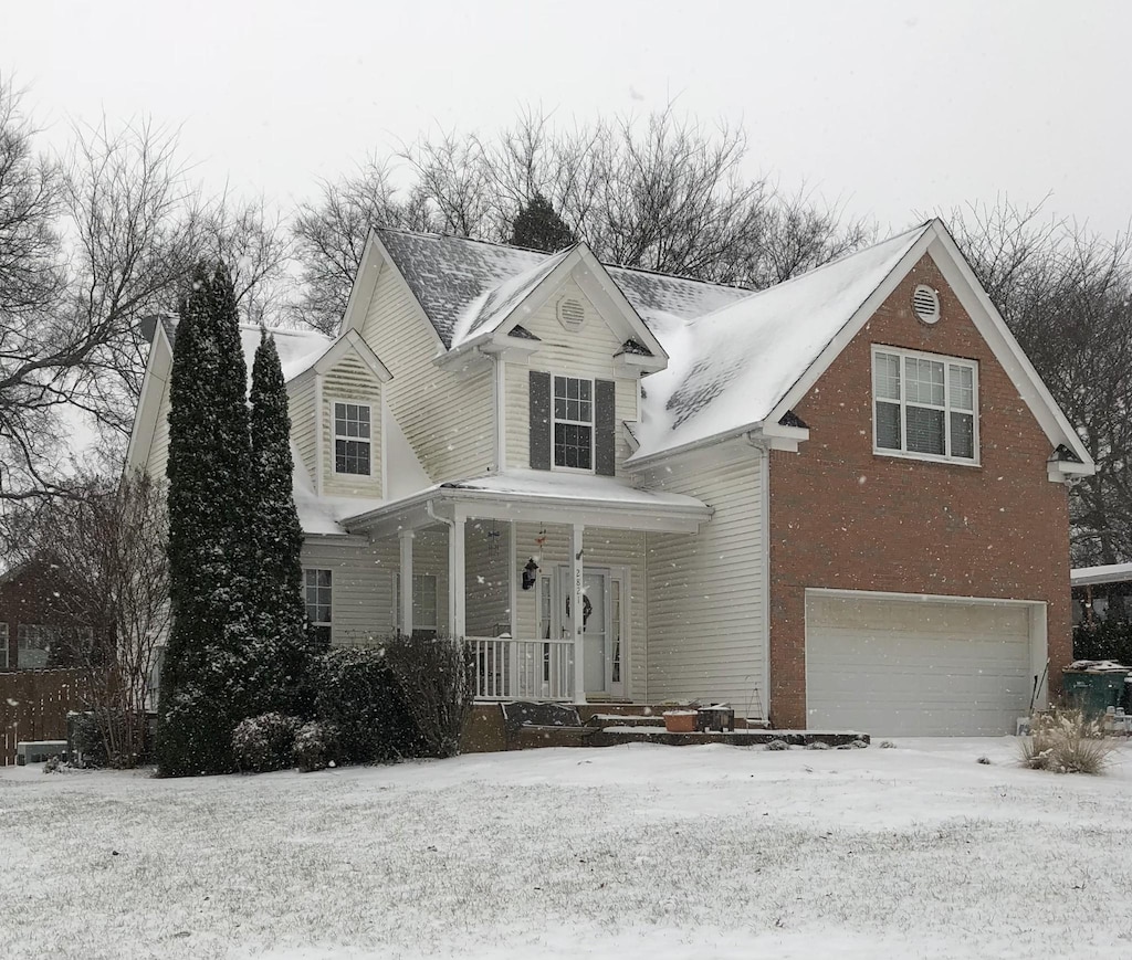 2821 Lafayette Dr, Thompsons Station, TN 37179 - traditional-style house featuring a porch, a garage, and brick siding