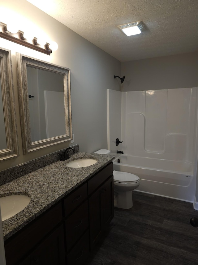 4070 Hartsville Rd, Lafayette, TN 37083 - full bath with double vanity, wood finished floors, a textured ceiling, and bathing tub / shower combination
